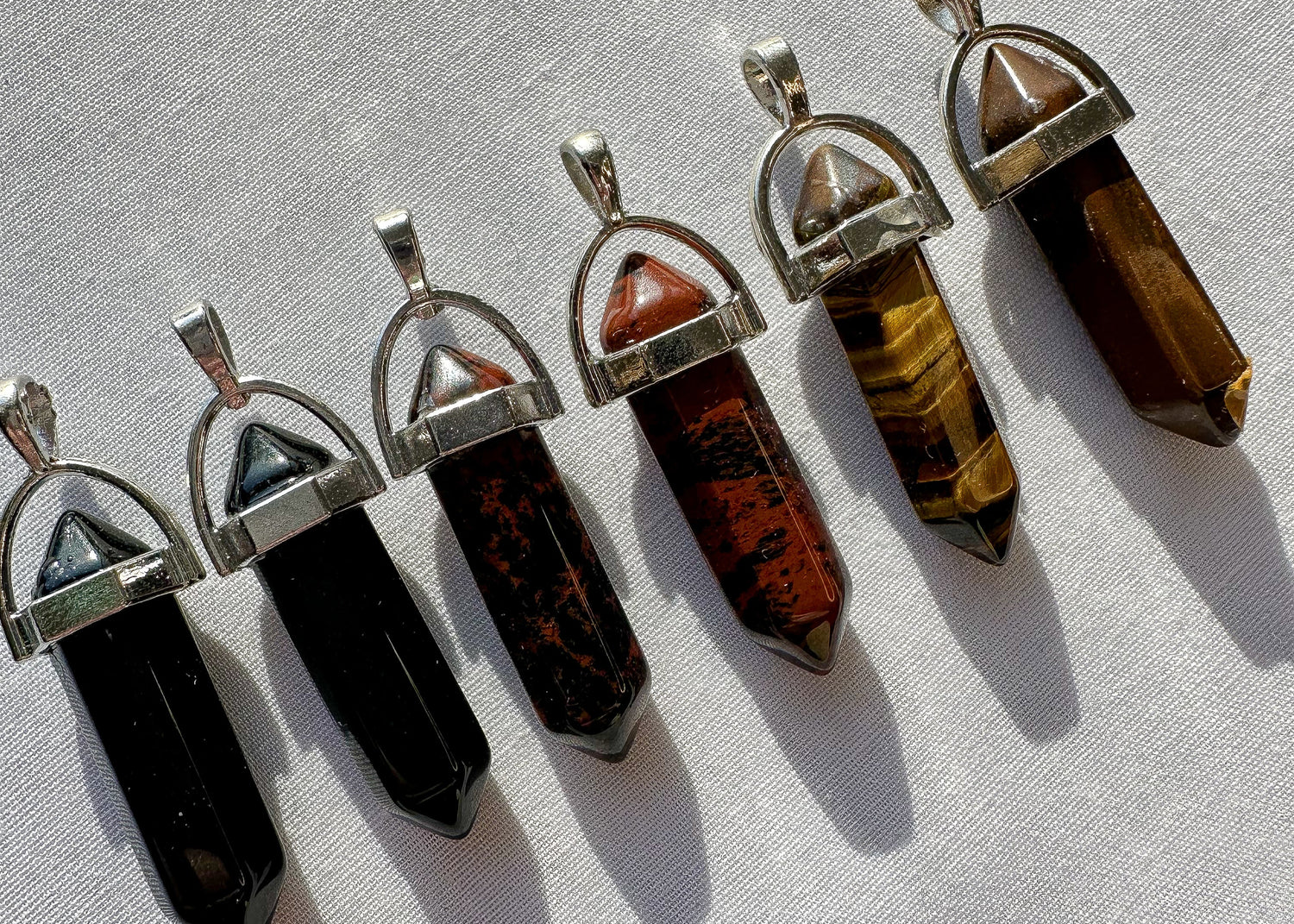 crystal pendants in tigers eye, obsidian and mahogany obsidian. 